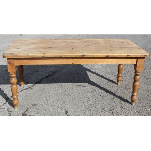 145 - A large pine farmhouse kitchen table, approx 180cm wide x 92cm deep x 78cm tall