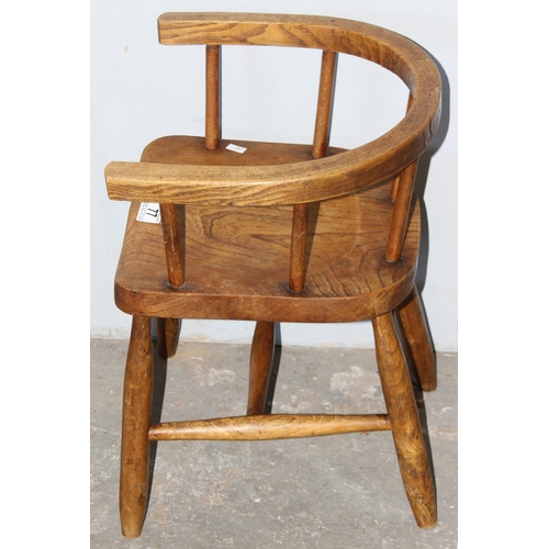 77 - A vintage Elm child's horseshoe chair, likely early 20th century, approx 48cm tall