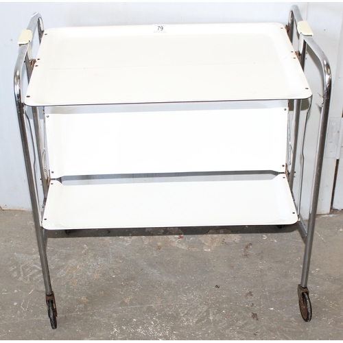 79 - A retro folding white Formica and chrome folding tea trolley, approx 66cm wide x 42cm deep x 71cm ta... 