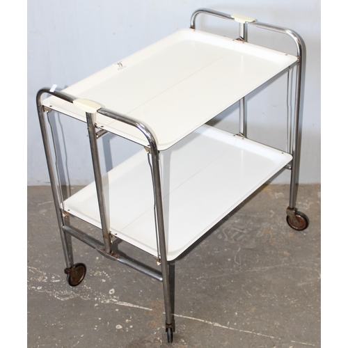 79 - A retro folding white Formica and chrome folding tea trolley, approx 66cm wide x 42cm deep x 71cm ta... 