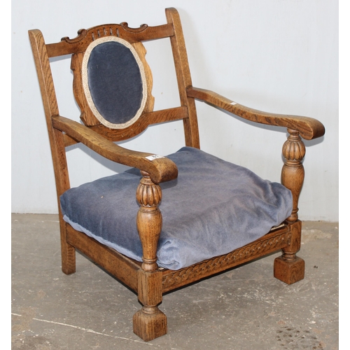 81 - An Art Deco period oak low chair with blue upholstery