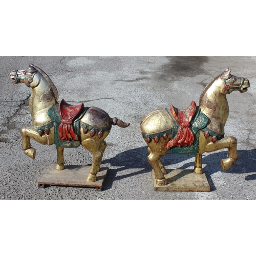 96 - Pair of large floor standing Chinese carved wooden horses with gilt and polychrome decoration, model... 