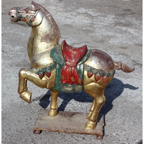 96 - Pair of large floor standing Chinese carved wooden horses with gilt and polychrome decoration, model... 