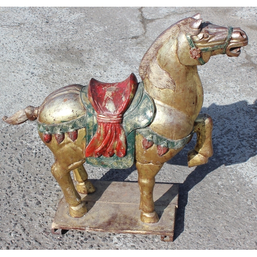 96 - Pair of large floor standing Chinese carved wooden horses with gilt and polychrome decoration, model... 