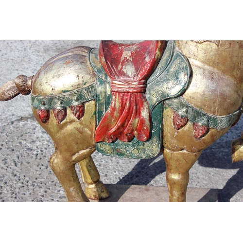 96 - Pair of large floor standing Chinese carved wooden horses with gilt and polychrome decoration, model... 