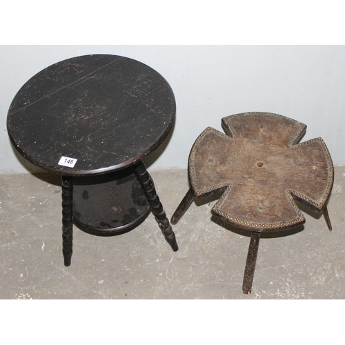 148 - A small antique ebonised tripod table with bobbin turned legs and an unusual Maltese cross shaped oa... 