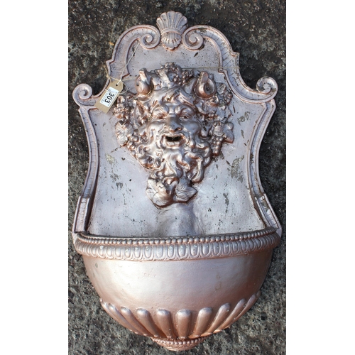 303 - A silver painted reconstituted stone wall mounted garden fountain, approx 63cm tall.