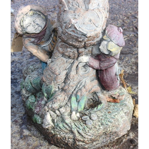 305 - A weathered concrete birdbath with painted figures, approx 40cm wide x 60cm tall