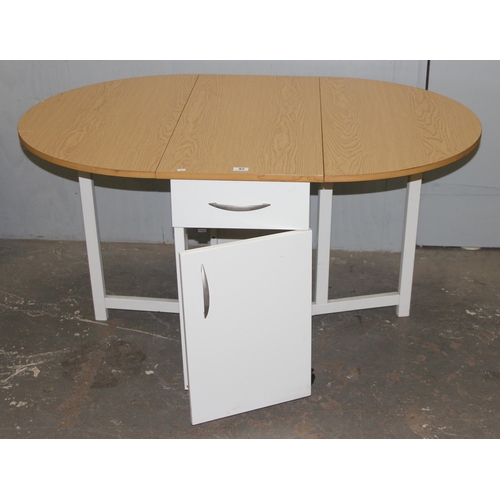 92 - A modern drop leaf table and 4 chairs, the chairs stowing away in the base of the table, approx 104c... 