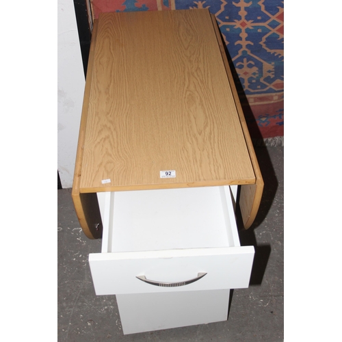 92 - A modern drop leaf table and 4 chairs, the chairs stowing away in the base of the table, approx 104c... 