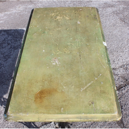 14 - A vintage tavern table with cast iron base and green painted wooden top, approx 120cm wide x 60cm de... 