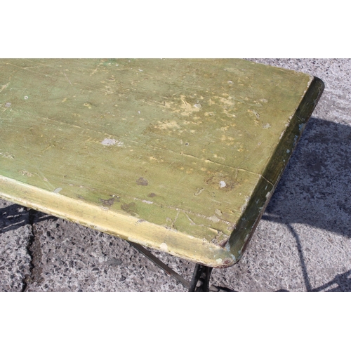 14 - A vintage tavern table with cast iron base and green painted wooden top, approx 120cm wide x 60cm de... 