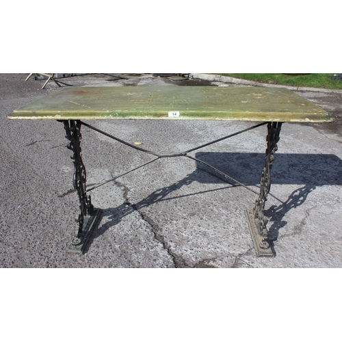 14 - A vintage tavern table with cast iron base and green painted wooden top, approx 120cm wide x 60cm de... 