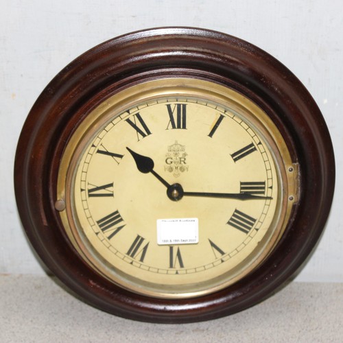 Circular mahogany cased 8 inch dial mechanical winding wall clock with key