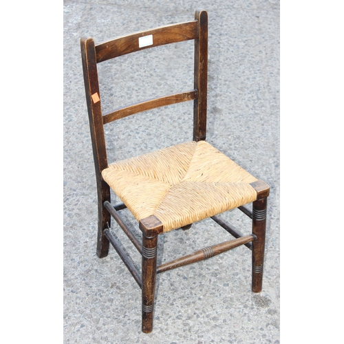 57 - An Arts & Crafts period oak child's chair with rush seat