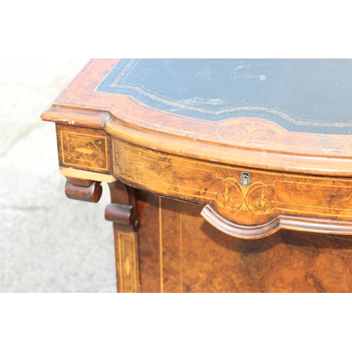 51 - A Victorian figured walnut kneehole writing Davenport, having a gilt tooled leather inset writing su... 