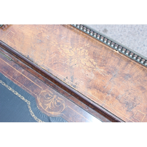 51 - A Victorian figured walnut kneehole writing Davenport, having a gilt tooled leather inset writing su... 