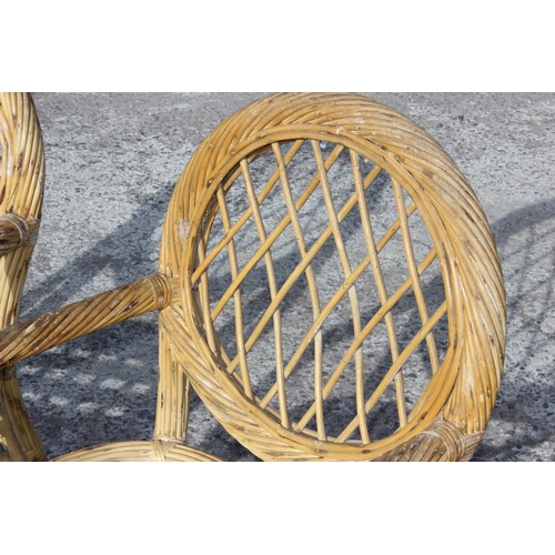 111 - A pair of vintage bamboo and wicker garden or conservatory chairs