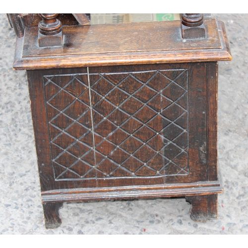 28 - An early 20th century carved oak monks bench with folding table top, approx 107cm wide x 48cm deep x... 