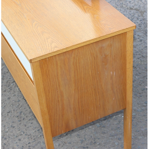 12 - A retro E Gomme G-Plan light oak 2 drawer dressing table with mirror with gold stamped label, approx... 