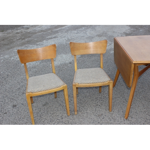 15 - A retro E Gomme G-Plan light oak drop leaf dining table and 4 chairs, all with gold stamped label, t... 