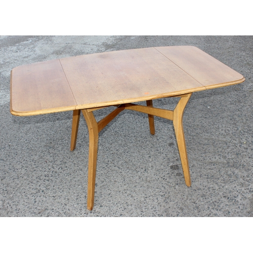 15 - A retro E Gomme G-Plan light oak drop leaf dining table and 4 chairs, all with gold stamped label, t... 