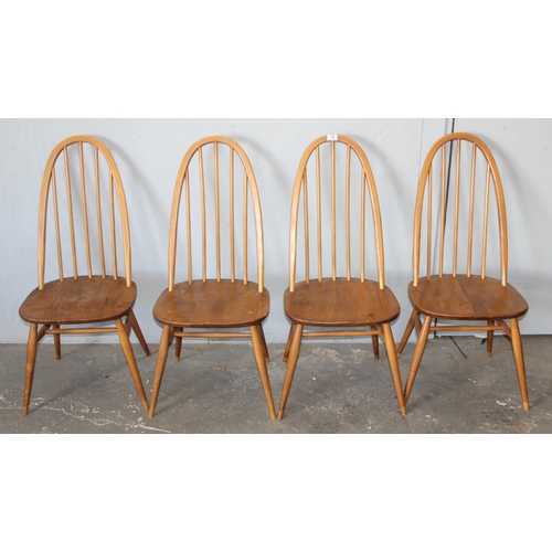 10 - A set of 4 blonde Ercol elm and beech hoop back dining chairs, On splayed tapering legs, with blue &... 