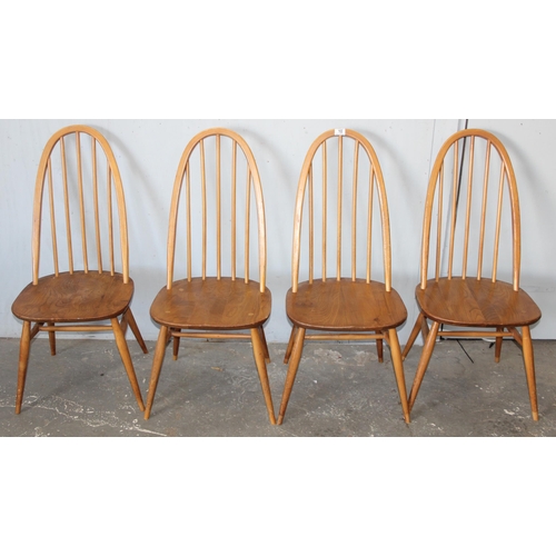 10 - A set of 4 blonde Ercol elm and beech hoop back dining chairs, On splayed tapering legs, with blue &... 