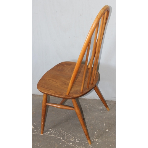 10 - A set of 4 blonde Ercol elm and beech hoop back dining chairs, On splayed tapering legs, with blue &... 