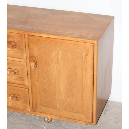 4 - A retro blonde Ercol 3 drawer 2 door sideboard, approx 155cm wide x 43cm deep x 67cm tall