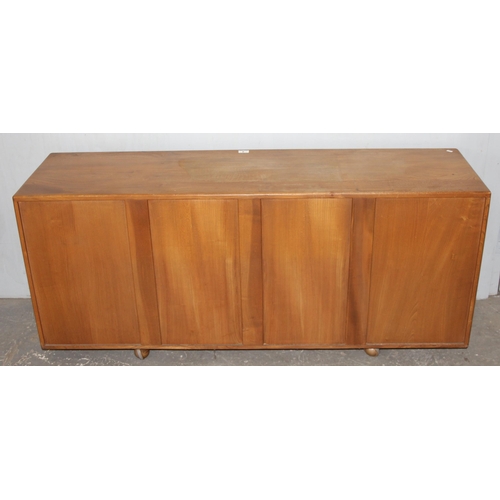 4 - A retro blonde Ercol 3 drawer 2 door sideboard, approx 155cm wide x 43cm deep x 67cm tall