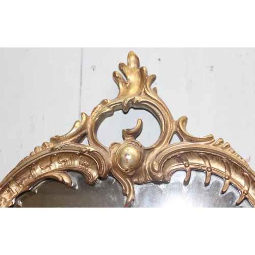 403 - A vintage Rococo style wall mirror made from carved wood, likely early 20th century, approx 89cm x 6... 