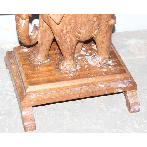 64 - An unusual vintage carved wooden table with elephant base, approx 77cm wide x 52cm deep x 54cm tall