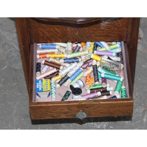 76 - A retro oak sewing box table on legs with contents, approx 48cm wide x 48cm deep x 48cm tall