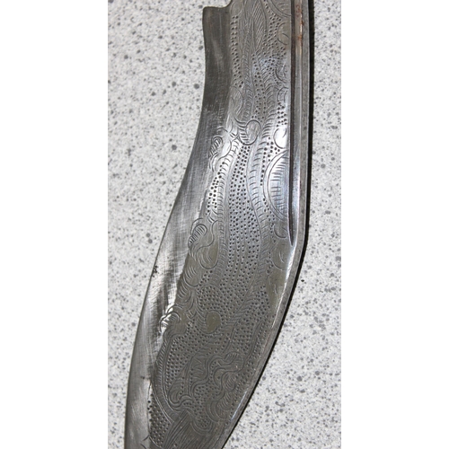 1434 - Small presentation Kukri knife with embossed blade in sheath with studded details, approx 28cm