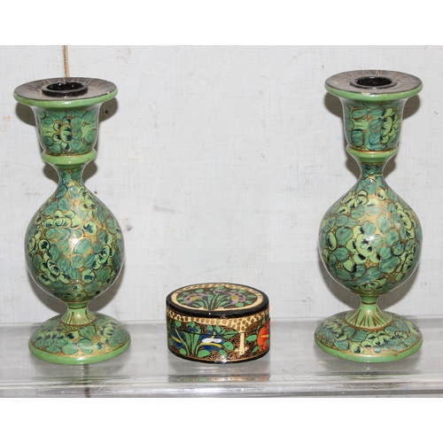 1604 - A pair of painted wooden Kashmiri style candlesticks and a similar box, the sticks approx 15cm tall