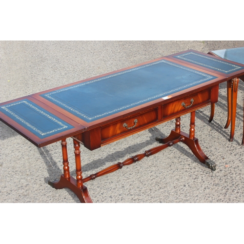 61A - Antique style reproduction leather topped drop-leaf low table on castors, and a similar nest of tabl... 