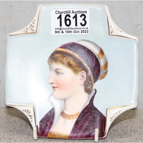 1613A - A small antique hand painted porcelain dish depicting the head of a 17th century maiden, unmarked bu... 