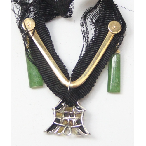 1128A - 3 necklaces to incl an unusual Art Deco period necklace on black fabric strap, the main pendant form... 