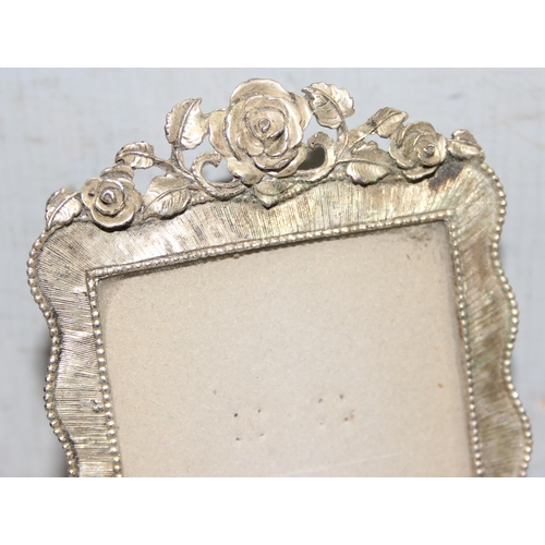 1037 - A pair of silver-plated photo frames with rose decoration, approx 16cm x 10cm