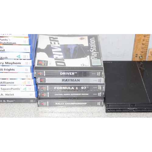 1521 - PlayStation 2 games console with 2 controllers and a remote control, with a selection of games (some... 