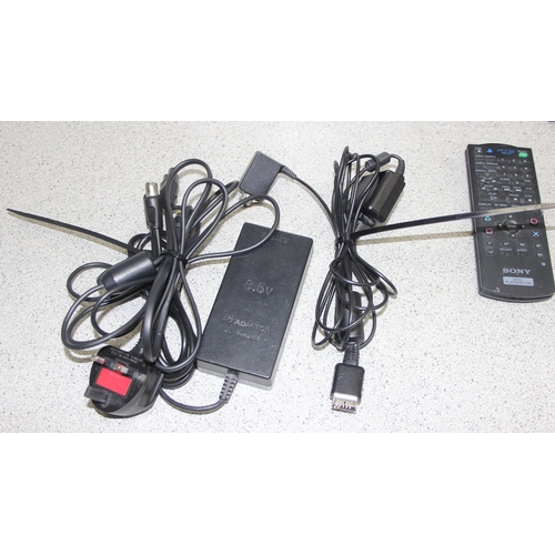 1521 - PlayStation 2 games console with 2 controllers and a remote control, with a selection of games (some... 