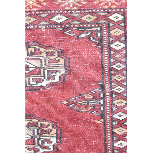 201 - Small red-ground Afghan rug (approx 87cm x 60cm), and a large vintage peach coloured throw (2)