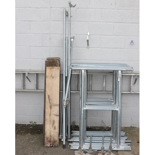 821 - Aluminium scaffold tower comprising of 14 H shaped sections, braces, planks and feet