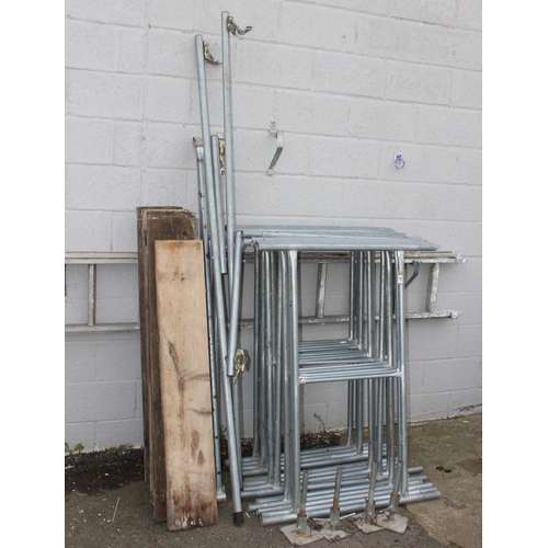 821 - Aluminium scaffold tower comprising of 14 H shaped sections, braces, planks and feet