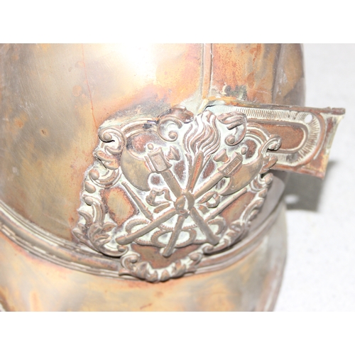 1442 - A vintage brass fireman's helmet, possibly a Merryweather with crossed axes mark, in parts