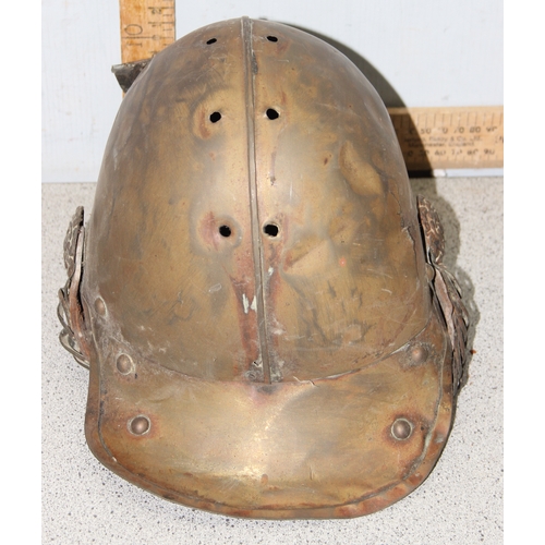 1442 - A vintage brass fireman's helmet, possibly a Merryweather with crossed axes mark, in parts