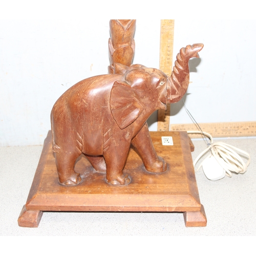 248 - Retro wooden standard lamp with carved palm tree details and elephant on base, approx 100cm tall