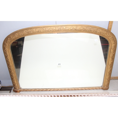 439 - Large over-mantel mirror in gilt frame with leaf motif, wooden panelling verso, approx 103cm x 67cm