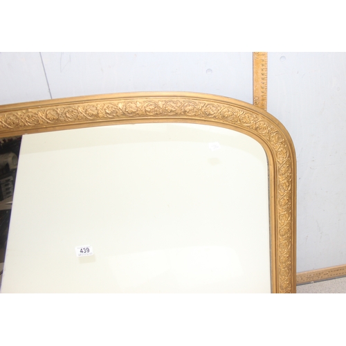 439 - Large over-mantel mirror in gilt frame with leaf motif, wooden panelling verso, approx 103cm x 67cm